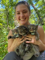 Ellen holding three cats